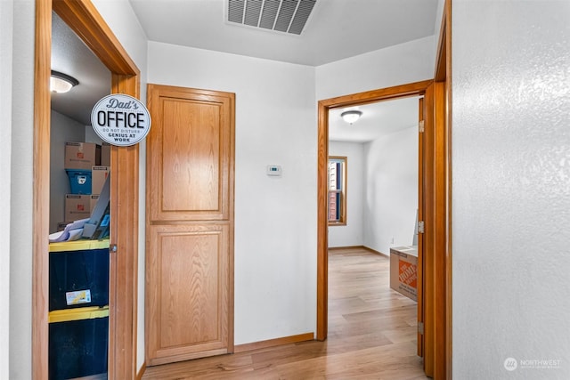 hall with light wood-type flooring