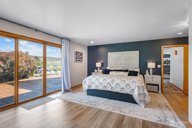 bedroom with access to exterior and light wood-type flooring