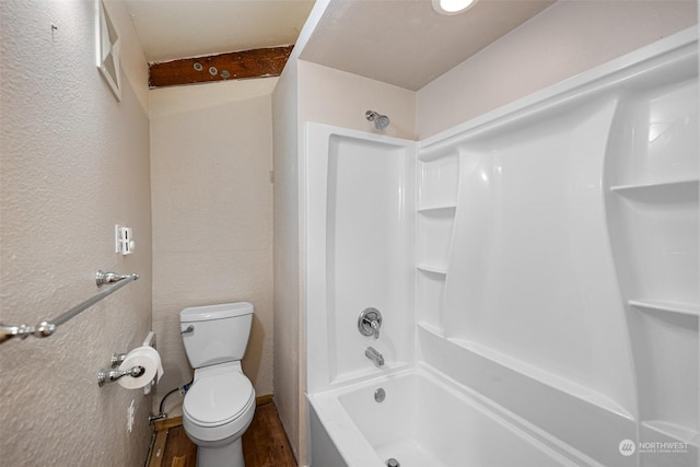 bathroom with shower / tub combination, wood-type flooring, and toilet