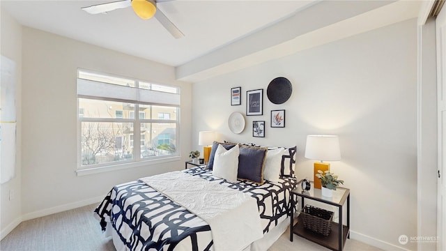 bedroom featuring ceiling fan and light carpet