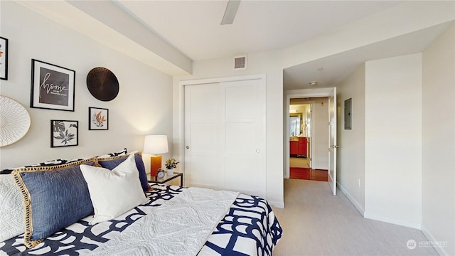 carpeted bedroom featuring a closet and ceiling fan