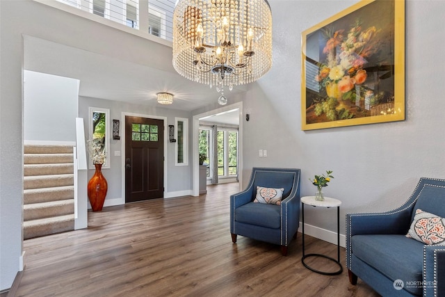 sitting room with an inviting chandelier and dark hardwood / wood-style flooring