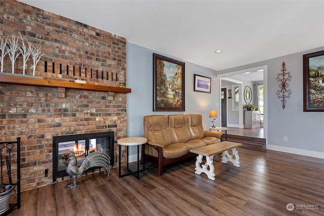 living room with dark hardwood / wood-style floors and a fireplace