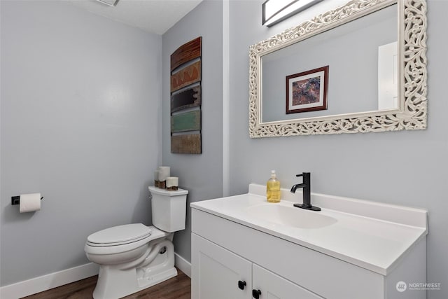 bathroom featuring vanity, toilet, and wood-type flooring