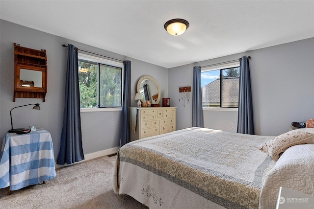 carpeted bedroom featuring multiple windows