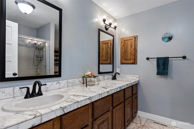 bathroom featuring vanity, a textured ceiling, and walk in shower