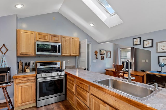 kitchen with dark wood-type flooring, lofted ceiling with skylight, sink, light brown cabinets, and appliances with stainless steel finishes