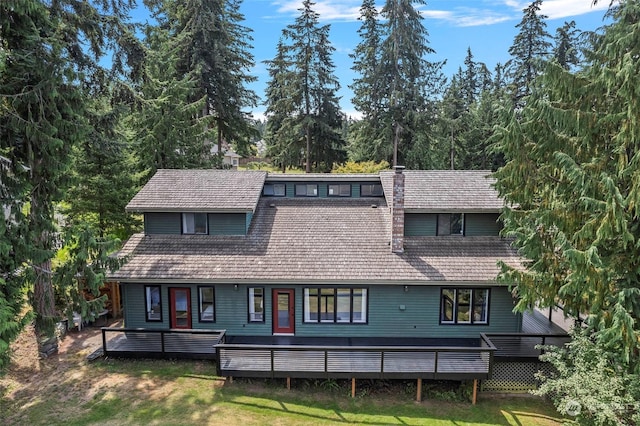 view of front of house featuring a wooden deck and a front lawn