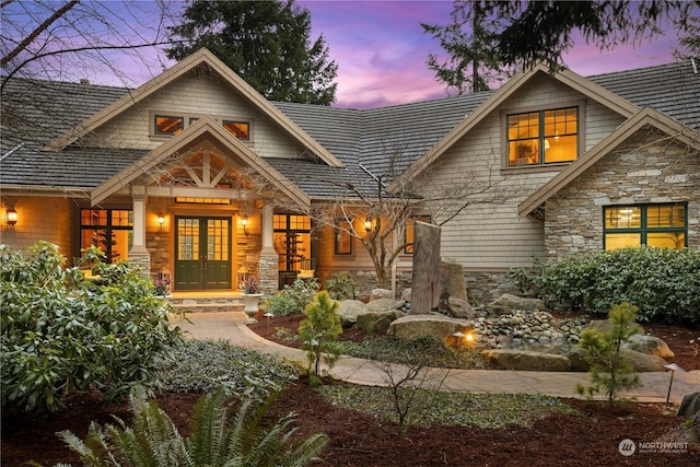 back house at dusk featuring french doors