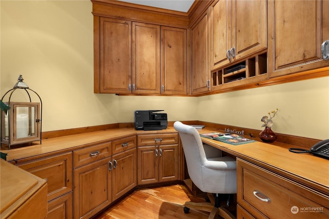 office area featuring built in desk and light wood-type flooring