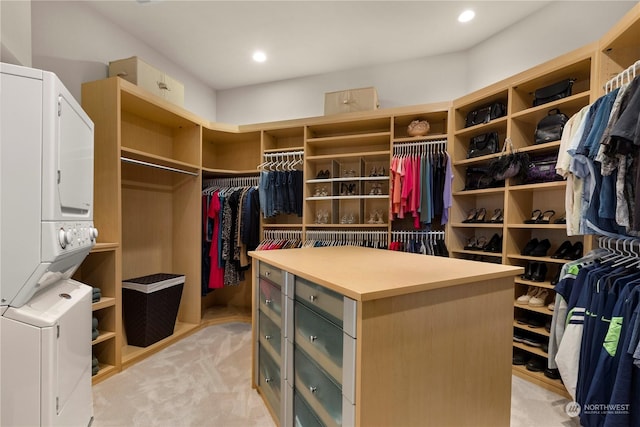 walk in closet with stacked washer and dryer and light colored carpet