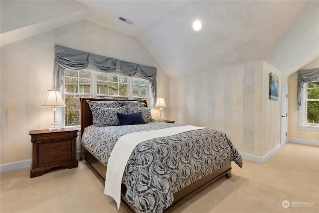 bedroom featuring vaulted ceiling and light carpet