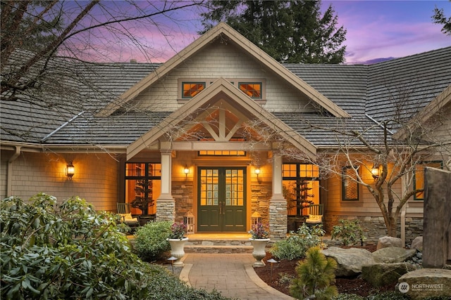 exterior entry at dusk featuring french doors