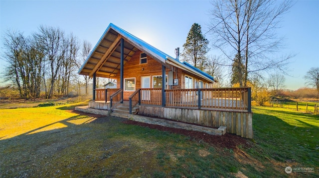 rear view of property with a yard and a deck