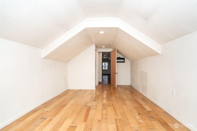 bonus room with hardwood / wood-style flooring and lofted ceiling