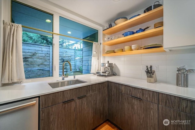 kitchen with sink, stainless steel dishwasher, dark brown cabinetry, and decorative backsplash