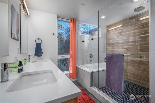 bathroom featuring vanity, tile patterned floors, and tiled shower / bath