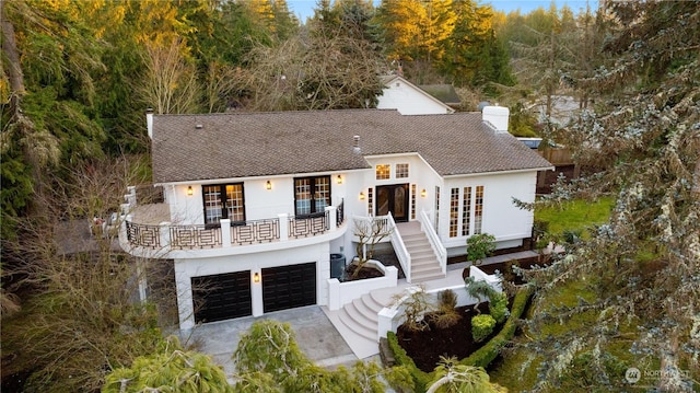 view of front of home featuring a balcony and a garage