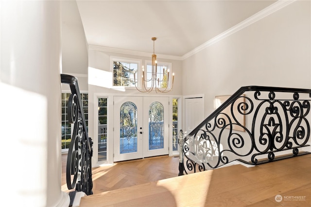 entrance foyer featuring parquet floors, crown molding, french doors, and a chandelier