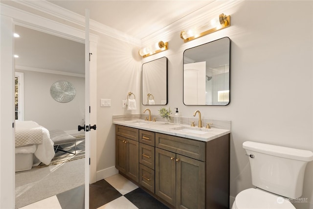 bathroom with vanity, crown molding, and toilet