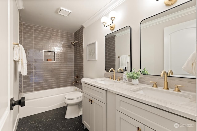 full bathroom featuring vanity, tiled shower / bath combo, ornamental molding, and toilet