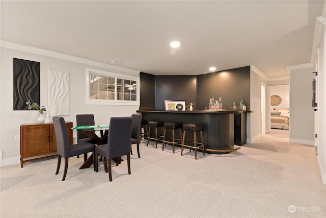 dining area with crown molding, light carpet, and bar