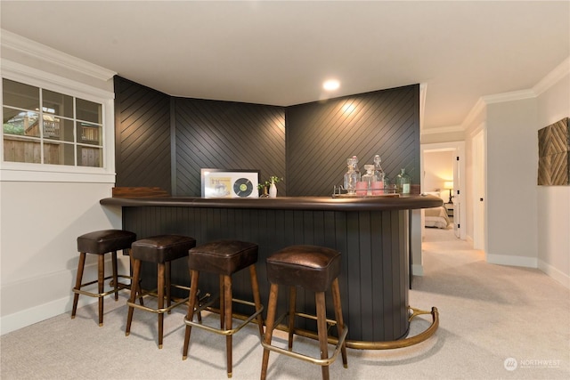 bar featuring light carpet and crown molding