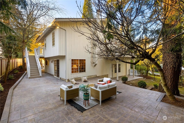 back of property with outdoor lounge area and a patio area