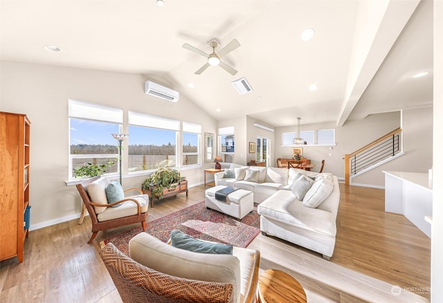 living room with ceiling fan, lofted ceiling, a wall unit AC, and light hardwood / wood-style floors