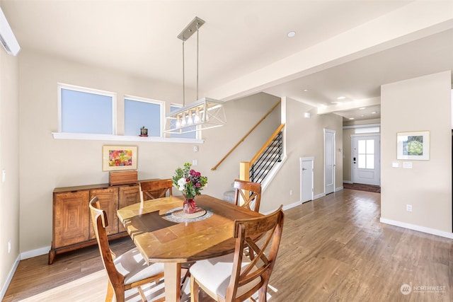 dining space with hardwood / wood-style flooring