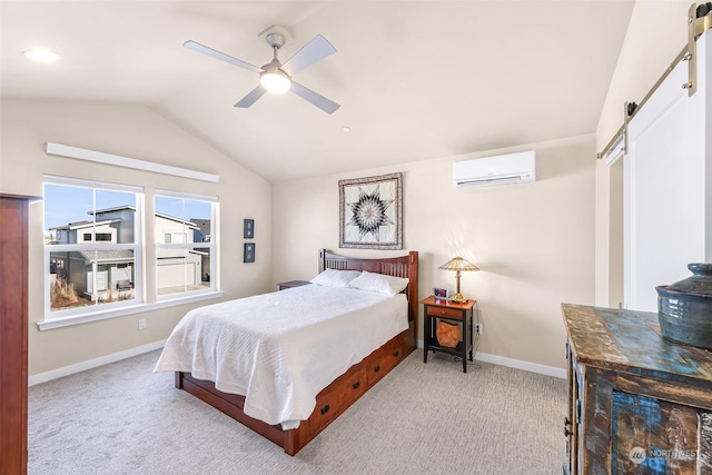 bedroom featuring light colored carpet, a wall mounted air conditioner, a barn door, and vaulted ceiling