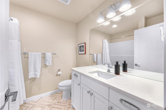 bathroom featuring parquet floors, vanity, and toilet