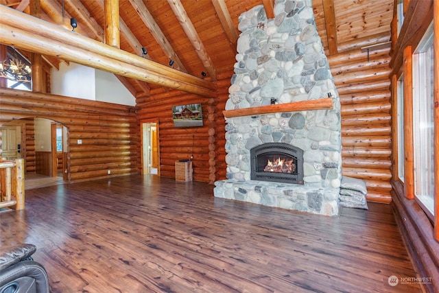 unfurnished living room featuring hardwood / wood-style flooring, high vaulted ceiling, a fireplace, wooden ceiling, and beamed ceiling