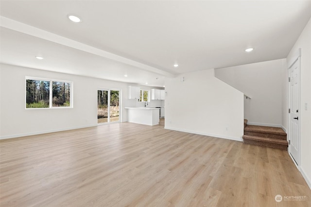 unfurnished living room featuring light hardwood / wood-style floors