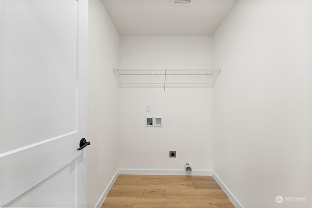 laundry room featuring washer hookup, wood-type flooring, and electric dryer hookup