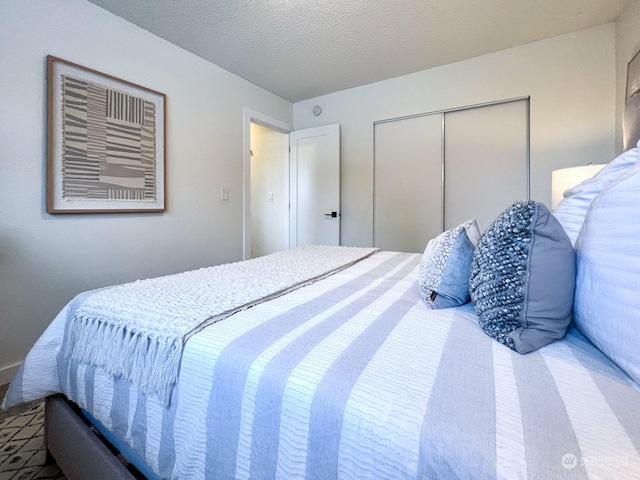 bedroom featuring a textured ceiling and a closet