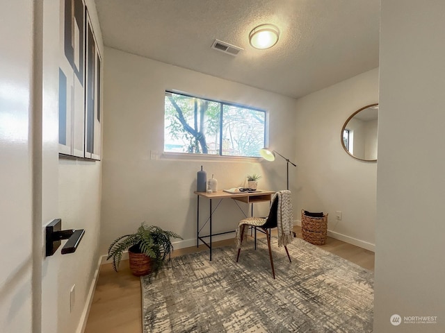 office area featuring hardwood / wood-style flooring and a textured ceiling