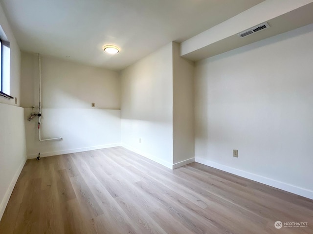 empty room with light hardwood / wood-style flooring