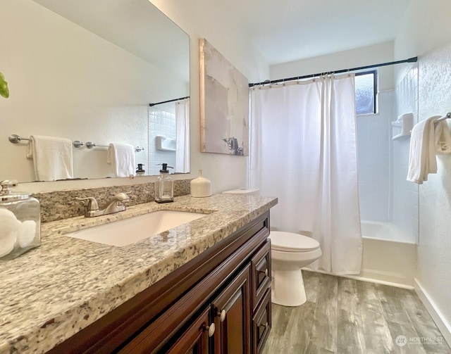 full bathroom featuring vanity, hardwood / wood-style floors, toilet, and shower / bath combo with shower curtain