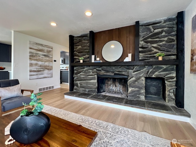 living room featuring a fireplace and hardwood / wood-style floors