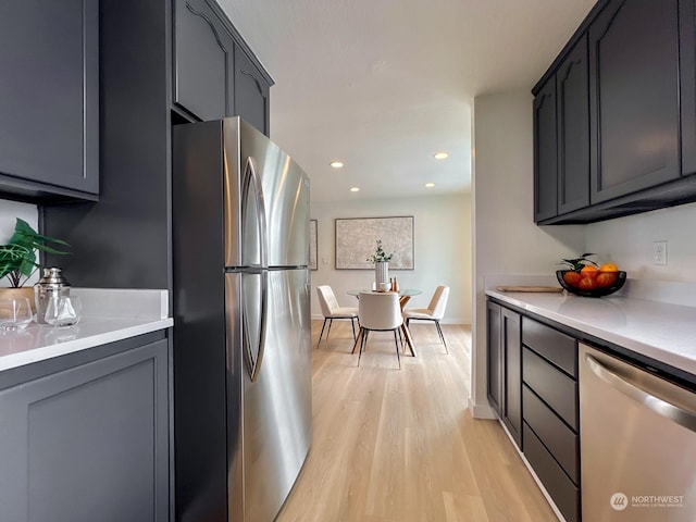 kitchen featuring stainless steel appliances and light hardwood / wood-style floors