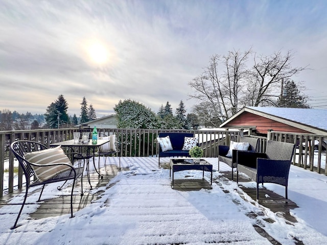 snow covered deck featuring outdoor lounge area