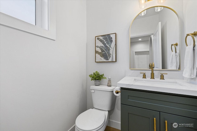 bathroom featuring vanity and toilet