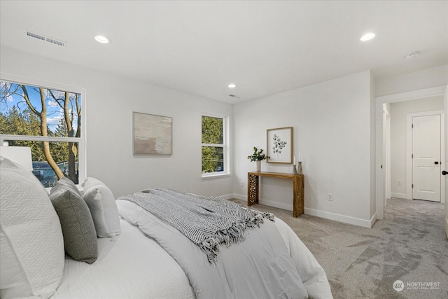 bedroom featuring light carpet and multiple windows