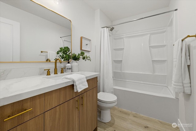 full bathroom featuring hardwood / wood-style flooring, vanity, shower / bathtub combination with curtain, and toilet