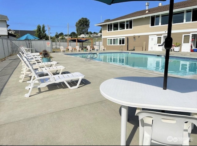 view of swimming pool with a patio area