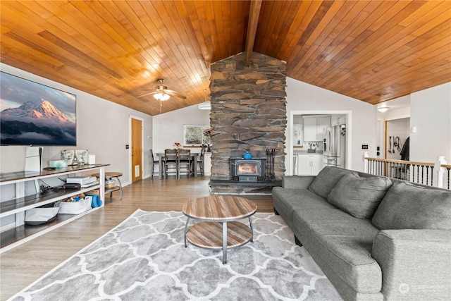 living room featuring wood ceiling, hardwood / wood-style flooring, lofted ceiling with beams, and ceiling fan