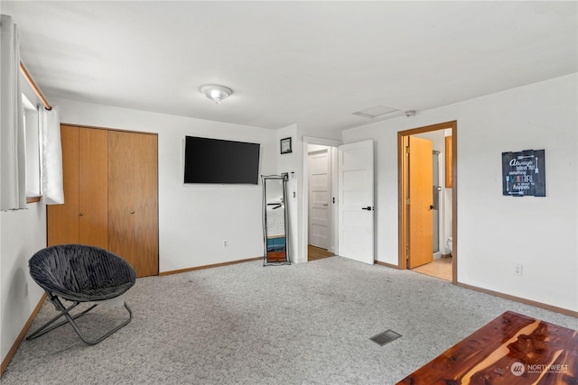 sitting room featuring light colored carpet