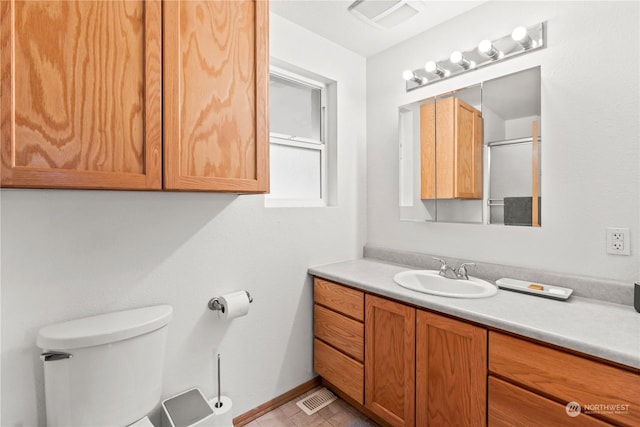 bathroom featuring vanity and toilet