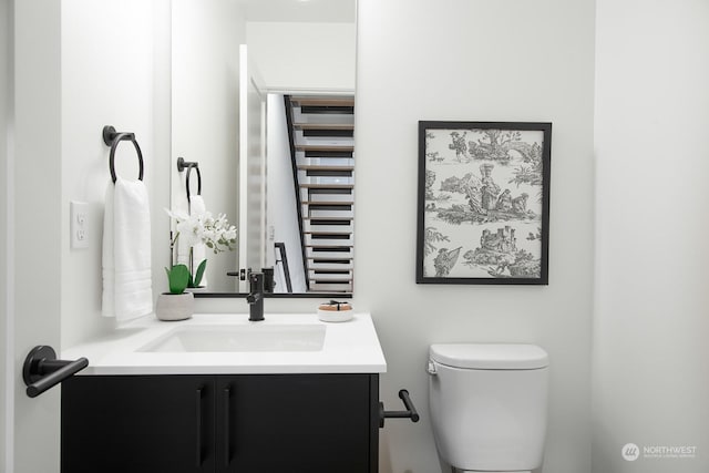 bathroom featuring vanity and toilet